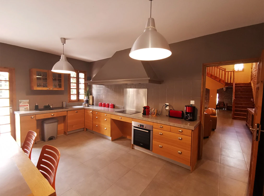 La cuisine équipée et sa grande table au Château Nadal Hainaut